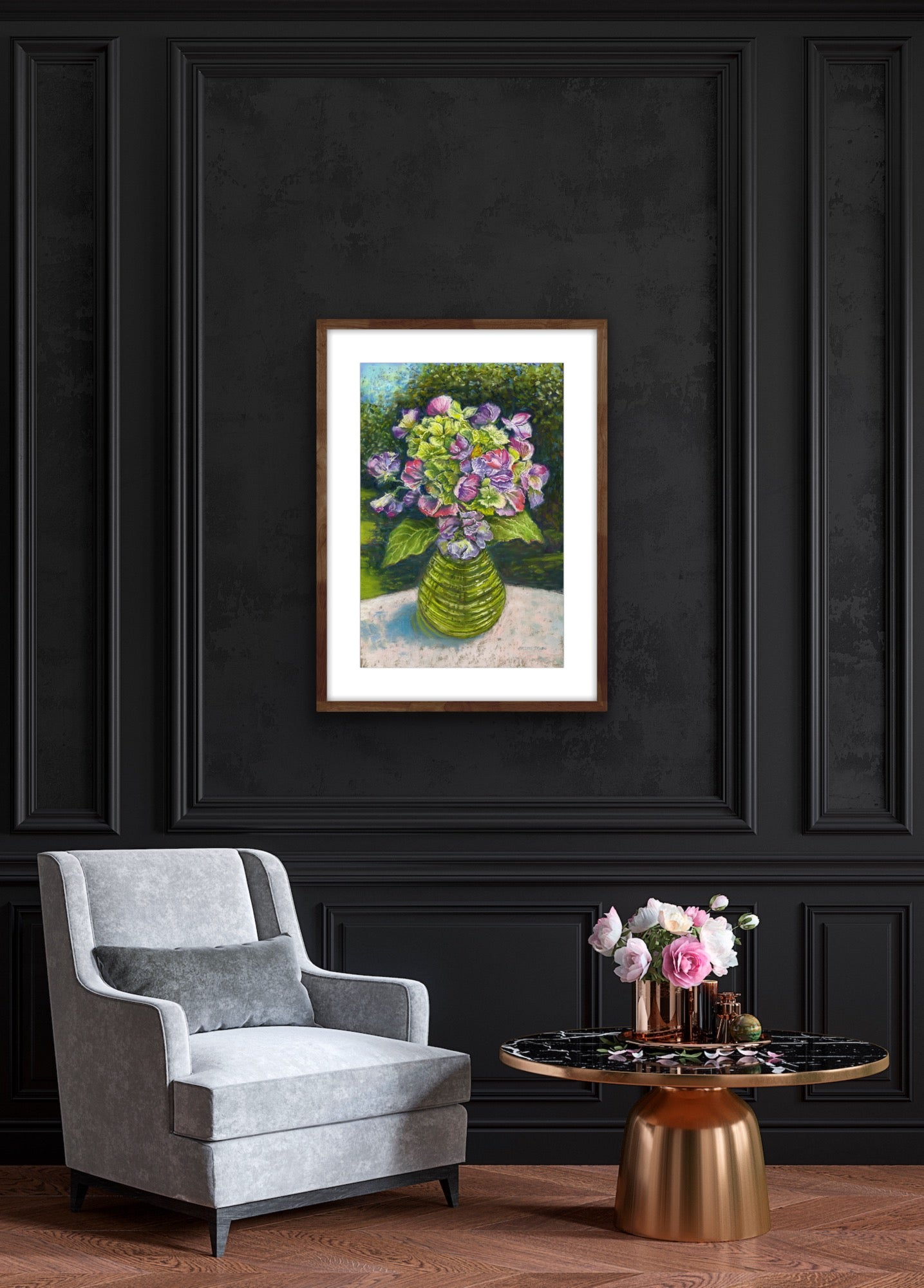 Sweetpeas and hydrangeas in a glass jar on a table cloth with dappled sunlight and trees and garden behind