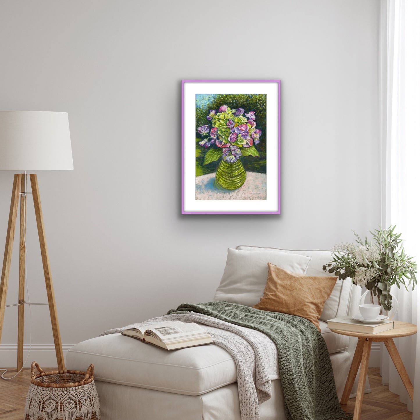 Sweetpeas and hydrangeas in a glass jar on a table cloth with dappled sunlight and trees and garden behind