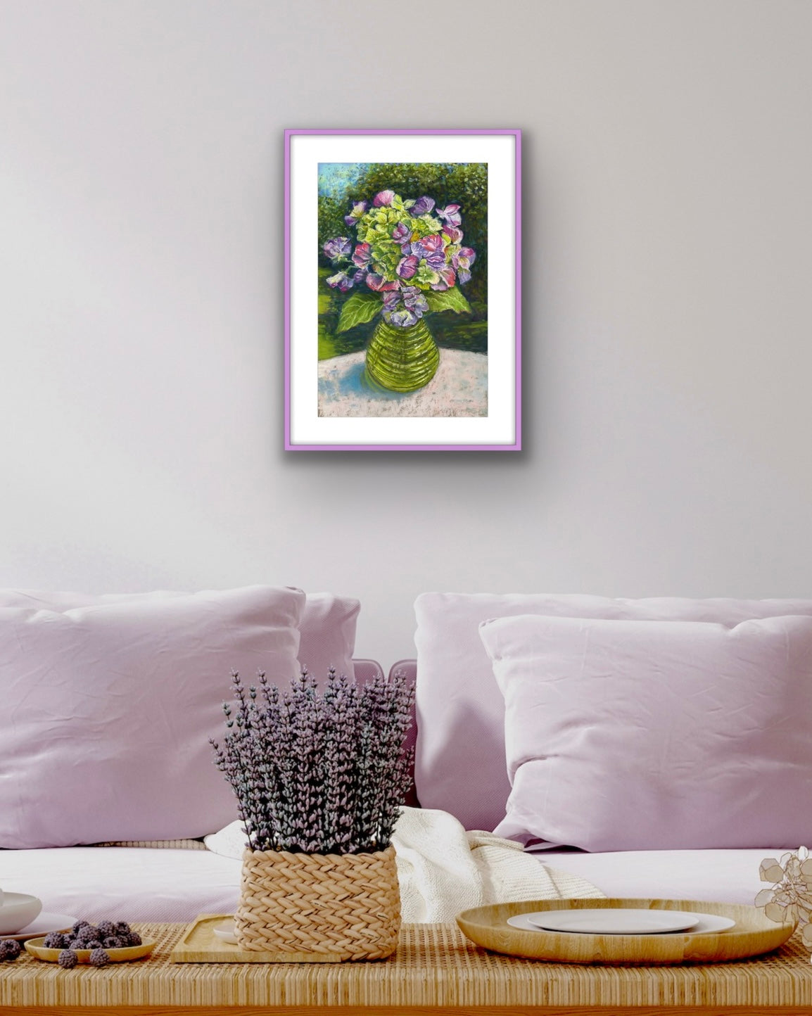 Sweetpeas and hydrangeas in a glass jar on a table cloth with dappled sunlight and trees and garden behind