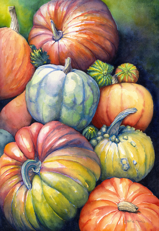 brightly coloured autumn fall pumpkins and squashes piled on top of each other with colourful background 