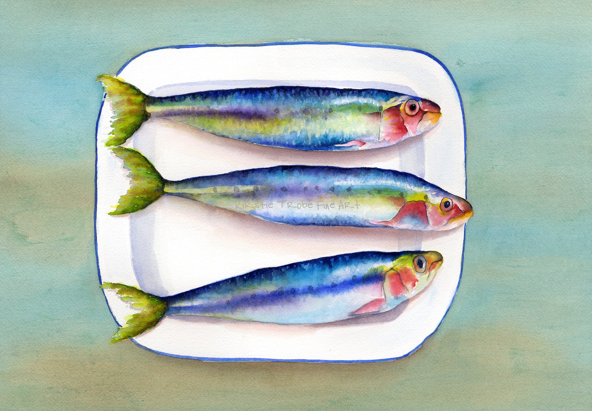 Three colourful Sardines lie on a white enamel plate that has a blue border with a green/brown background beneath it. They face to the right and their shiny scales are painted in a rainbow of colours.